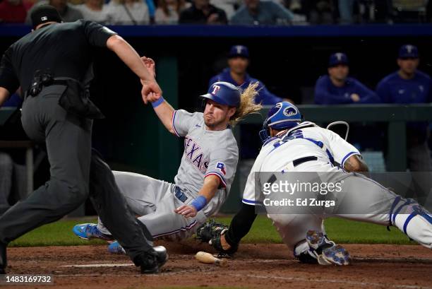 Travis Jankowski of the Texas Rangers is tagged out at the plate by Salvador Perez of the Kansas City Royals in the sixth inning at Kauffman Stadium...
