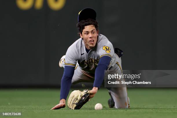 Christian Yelich of the Milwaukee Brewers dives for a ball but comes up short for a catch against the Seattle Mariners during the third inning at...