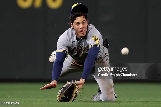 Christian Yelich of the Milwaukee Brewers dives for a ball but comes up short for a catch against the Seattle Mariners during the third inning at...