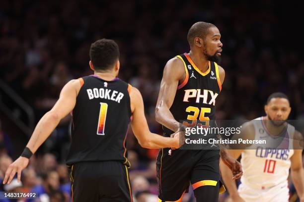 Kevin Durant of the Phoenix Suns high fives Devin Booker after scoring against the LA Clippers during the first half of Game Two of the Western...