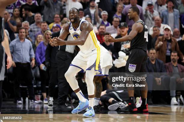 Draymond Green of the Golden State Warriors reacts after he got tangled with Domantas Sabonis of the Sacramento Kings in the second half during Game...