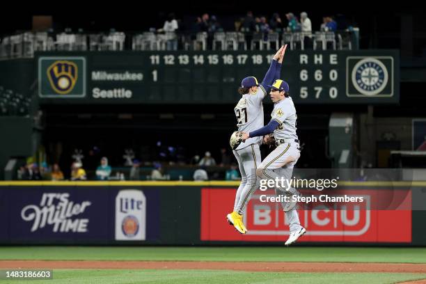 Willy Adames and Christian Yelich of the Milwaukee Brewers celebrate their 6-5 win against the Seattle Mariners at T-Mobile Park on April 18, 2023 in...