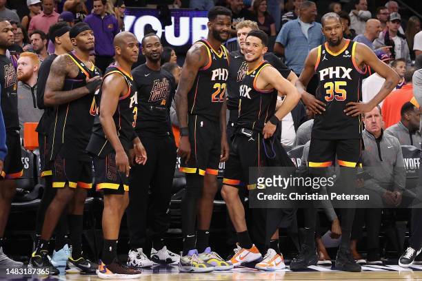 Torrey Craig, Chris Paul, Terrence Ross, Deandre Ayton, Devin Booker and Kevin Durant of the Phoenix Suns react on the bench during the final moments...