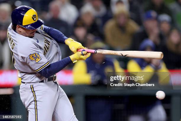 Willy Adames of the Milwaukee Brewers breaks his bat as he grounds out and scores a run during the eleventh inning against the Seattle Mariners at...