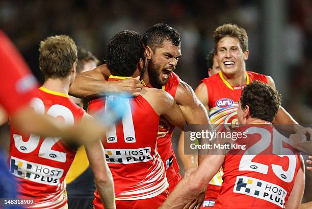 Karmichael Hunt of the Suns celebrates with team mates after kicking the match winning goal after the final siren during the round 16 AFL match...