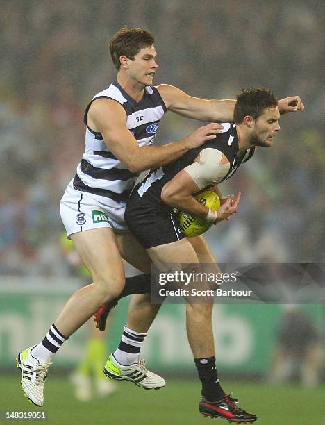 Tom Hawkins of the Cats and Nathan Brown of the Magpies compete for the ball during the AFL Round 16 game between the Geelong Cats and the...