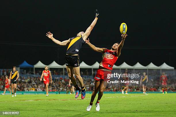 Harley Bennell of the Suns marks behind Brett Deledio of the Tigers during the round 16 AFL match between the Richmond Tigers and the Gold Coast Suns...