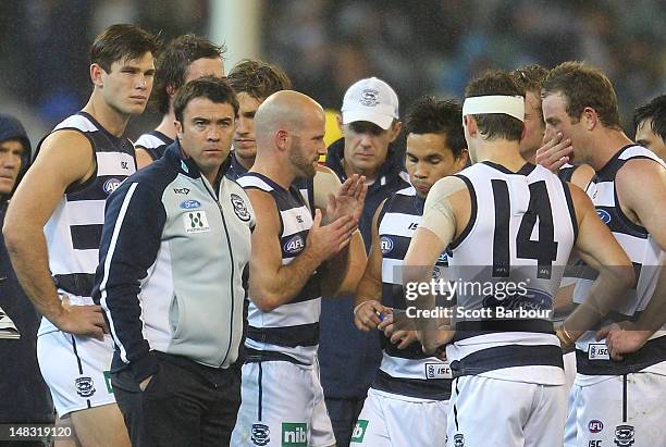 Chris Scott, coach of the Cats speaks to his team during a break during the AFL Round 16 game between the Geelong Cats and the Collingwood Magpies at...