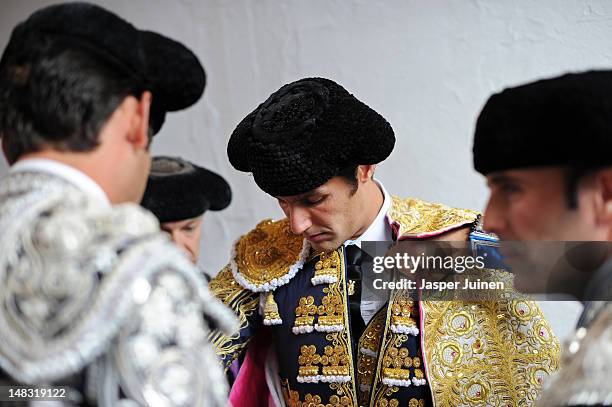 Bullfighter is helped getting dressed before entering the bullring for a bullfight on the fourth day of the San Fermin running-of-the-bulls on July...