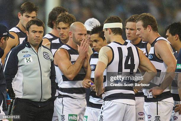 Chris Scott, coach of the Cats speaks to his team during a break during the AFL Round 16 game between the Geelong Cats and the Collingwood Magpies at...