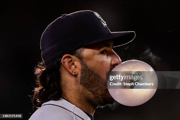 Eugenio Suarez of the Seattle Mariners blows a bubble during the third inning against the Milwaukee Brewers at T-Mobile Park on April 18, 2023 in...