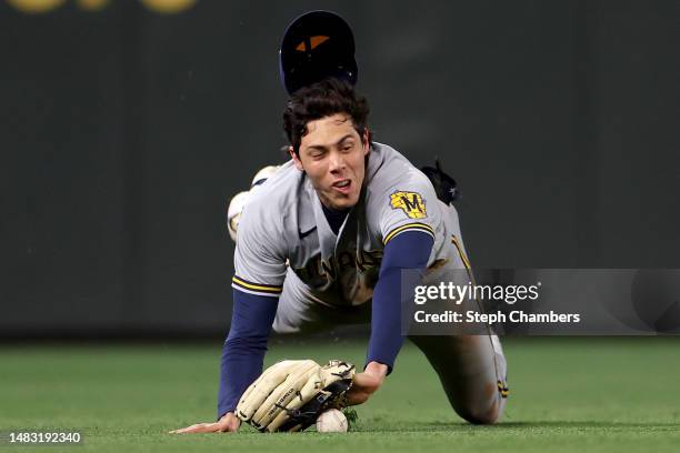 Christian Yelich of the Milwaukee Brewers dives for a ball but comes up short for a catch against the Seattle Mariners during the third inning at...