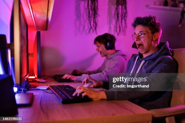 teenage boys playing video game on desktop pc - defeat funny stock pictures, royalty-free photos & images