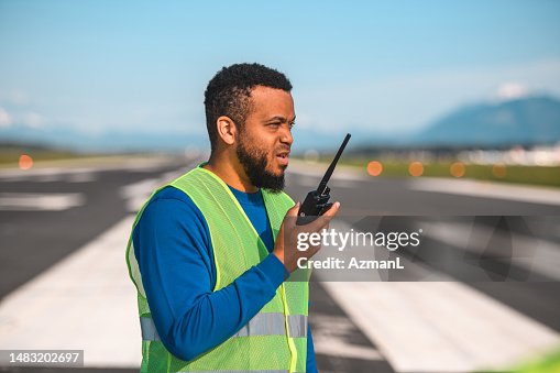 Latin Male Airfield Operations Officer Observing A Situation On A Runway Latin Male Airfield Operations Officer Observing A Situation On A Runway