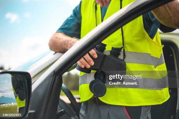 airfield operations officer holding binoculars - flight operations officer stock pictures, royalty-free photos & images