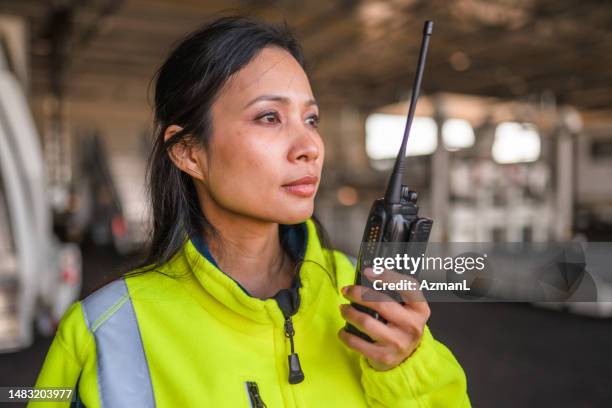 asian female airport worker in a reflective vest - cbs stock pictures, royalty-free photos & images