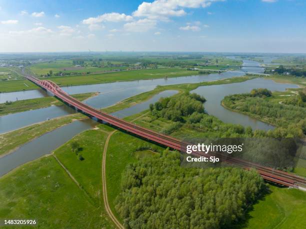 hanzeboog train bridge over the river ijssel - zwolle stock pictures, royalty-free photos & images