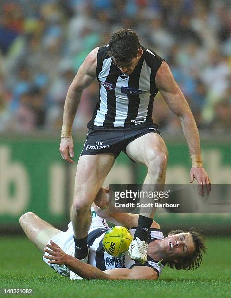Tyson Goldsack of the Magpies and Josh Walker of the Cats compete for the ball during the AFL Round 16 game between the Geelong Cats and the...