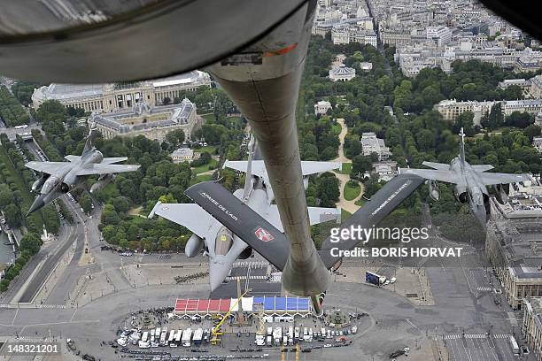 Picture taken from a Boeing C135, refueling tanker, shows of two French Rafale fighters and two Mirage fighters, as they fly over the Arc de Triomphe...