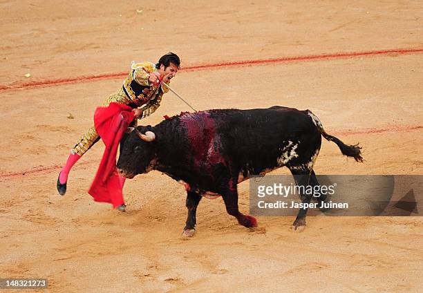 Bullfighter pushes his sword into an El Pilar fighting bull to kill it on the fourth day of the San Fermin running-of-the-bulls on July 10, 2012 in...