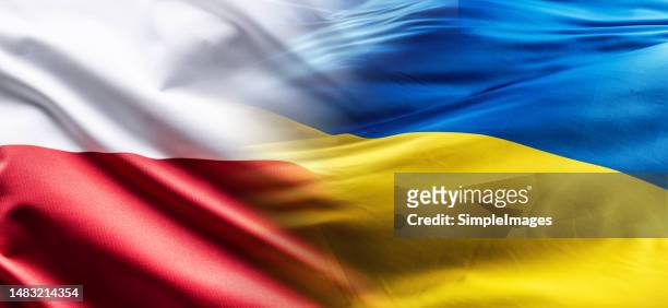 polish and ukrainian flags flutter together in the wind - polish flag stock pictures, royalty-free photos & images