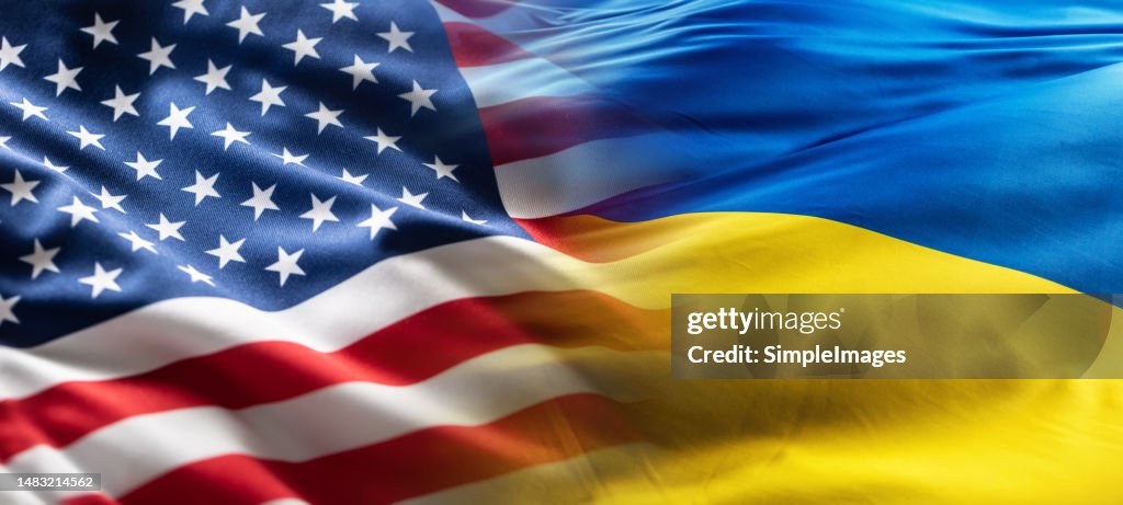 American and Ukrainian flags flutter together in the wind.
