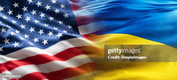 american and ukrainian flags flutter together in the wind. - bandeira-da-ucrânia imagens e fotografias de stock