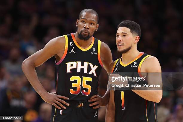 Kevin Durant and Devin Booker of the Phoenix Suns talk during the second half of Game Two of the Western Conference First Round Playoffs against the...