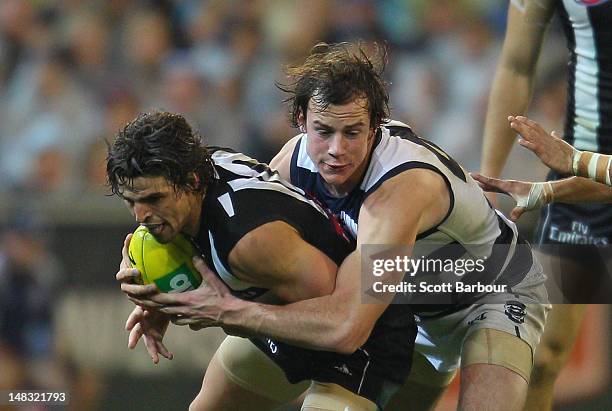 Scott Pendlebury of the Magpies is tackled during the AFL Round 16 game between the Geelong Cats and the Collingwood Magpies at the Melbourne Cricket...