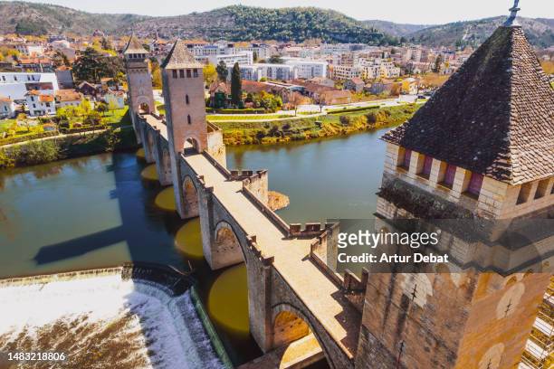 aerial view of the cahors medieval bridge in the south of france with creative angle. - cahors stock pictures, royalty-free photos & images