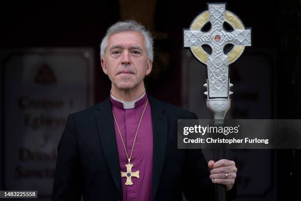 Archbishop of Wales Andrew John poses with the Cross of Wales ahead of the blessing of the cross at Holy Trinity Church, Llandudno on April 19, 2023...