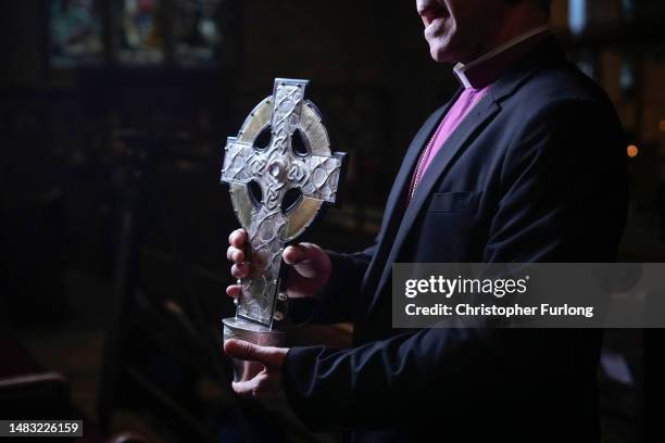 Archbishop of Wales Andrew John poses with the Cross of Wales ahead of the blessing of the cross at Holy Trinity Church, Llandudno on April 19, 2023...