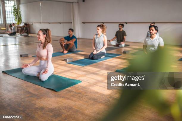 multiethnic group of men and women during  meditation - yoga studio stock pictures, royalty-free photos & images