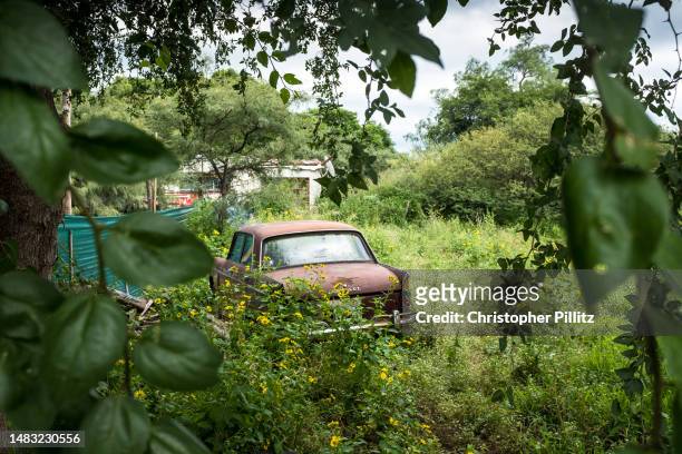 The remains of a Peugeot 404 lies abandoned in a field off a dusty earth road on March 28, 2023 in San Marcos Sierra town, Córdoba, Argentina.