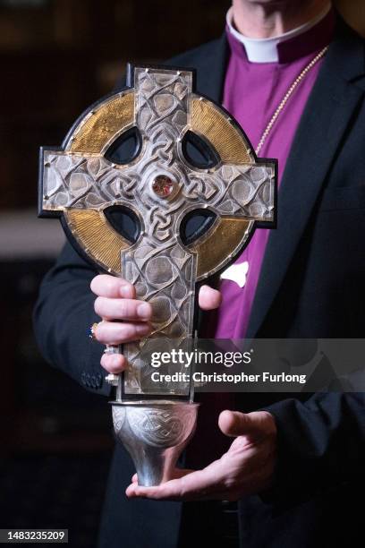 Archbishop of Wales Andrew John poses with the Cross of Wales ahead of the blessing of the cross at Holy Trinity Church, Llandudno on April 19, 2023...