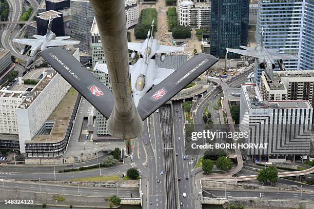 Picture taken from a Boeing C135, refueling tanker, showing two French Rafale fighters and two Mirage fighters, as they fly over La Defense business...