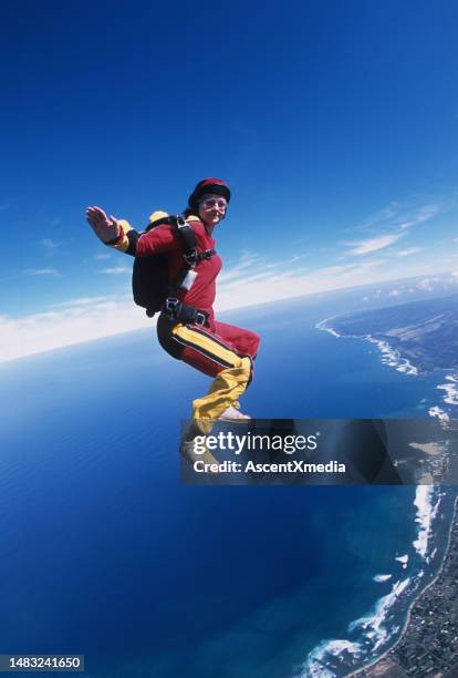 skydiver in free fall above sea - older woman skydiving stock pictures, royalty-free photos & images