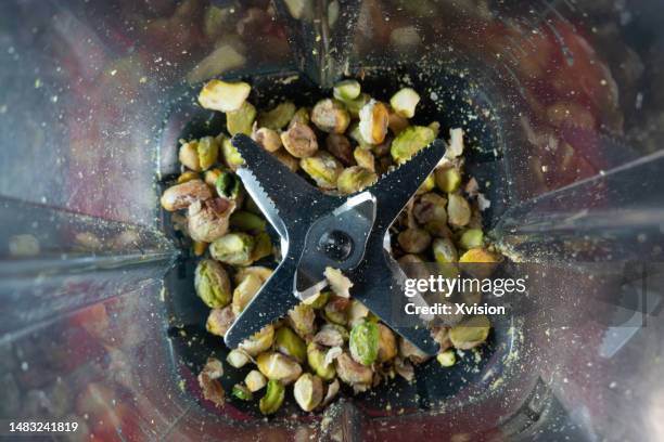 pistachio under high speed blending synced in high speed photography - blender stock pictures, royalty-free photos & images