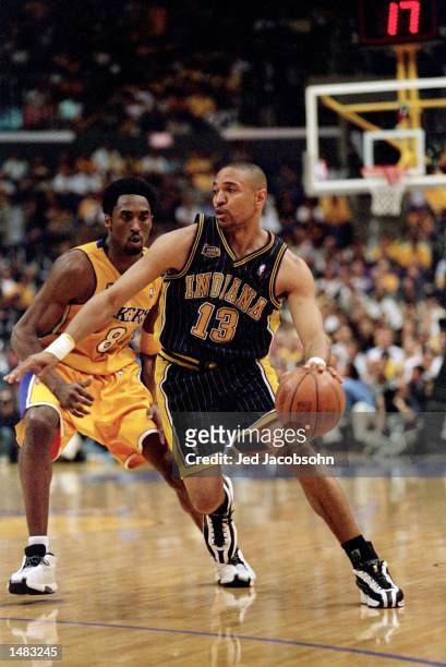 Mark Jackson of the Indiana Pacers dribbles the ball down the court as he is guarded by Kobe Bryant of the Los Angeles Lakers during the NBA Finals...