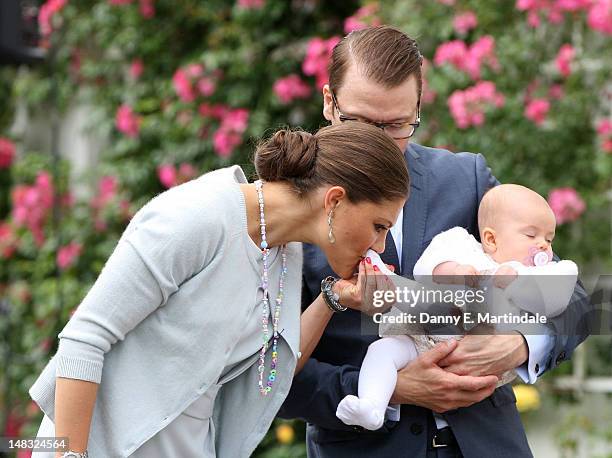 Swedish Crown Princess Victoria kisses the foot of Princess Estelle as Prince Daniel holds their her during her 35th birthday at Solliden on July 14,...