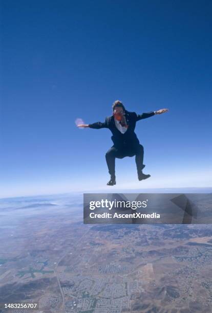 skydiver wearing business suit in free fall - super excited suit stock pictures, royalty-free photos & images