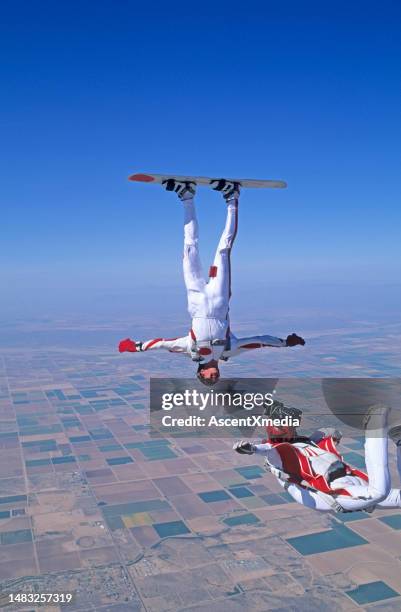 skydiver photographs skyboarder in the air - upside down stock pictures, royalty-free photos & images