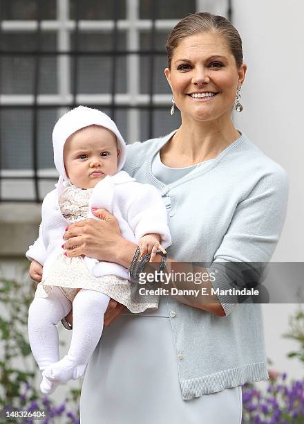 Swedish Crown Princess Victoria holds her daughter Princess Estelle during an event celebrating her 35th birthday at Borgholm's Idrottsplats on July...