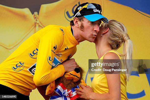 Bradley Wiggins of Great Britain riding for Sky Procycling takes the podium after defending the race leader's yellow jersey in stage thirteen of the...