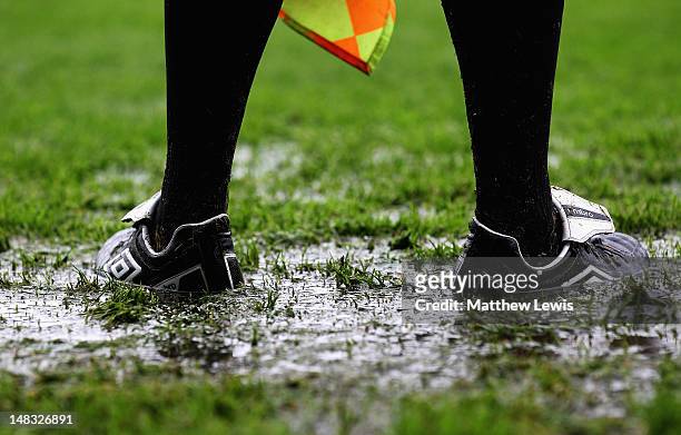 Linesman stands in a puddle during the Pre-Season Friendly match between Southend United and West Ham United at Roots Hall on July 14, 2012 in...