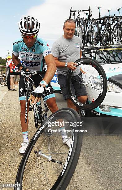 Mechanic performs a wheel change for Jerome Pineau of France and Omega Pharma-Quick Step after he punctured in the break away group during stage...