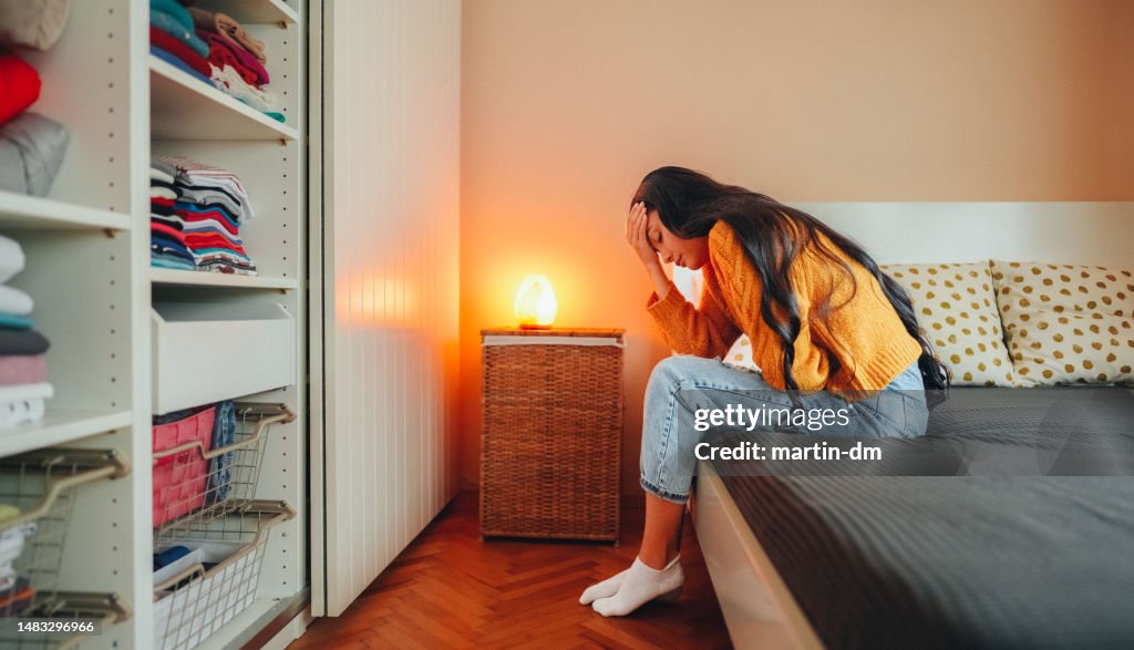 Woman with stomach pain staying home