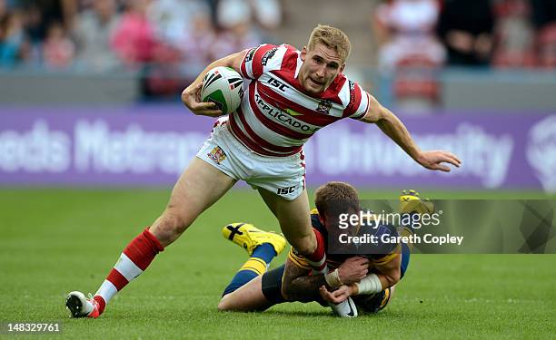 Sam Tomkins of Wigan breaks the tackle Zak Hardaker of Leeds during the Carnegie Challenge Cup Semi Final match between Leeds Rhinos and Wigan...