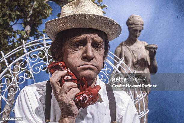 View of American actor John Byner, in a straw hat, on the set of a corporate video, commissioned by Ohio Bell, in the company's television studio,...
