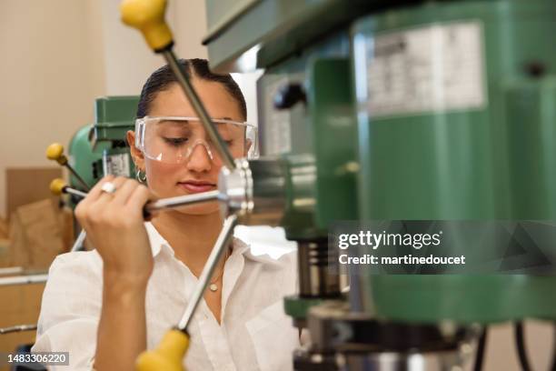 girls in stem, science student operating machinery in workshop. - operating machinery stock pictures, royalty-free photos & images